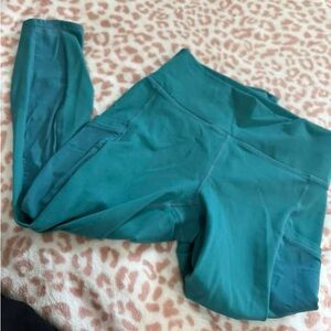 Fabletics Mila leggings in teal. Dark blue is from the website.